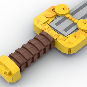 May include: A yellow and brown Lego sword with a detailed handle and a silver blade.