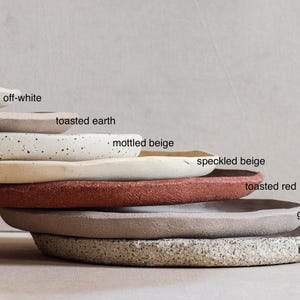 Seven stacked stoneware plates made from different clays to show the variety of shades available