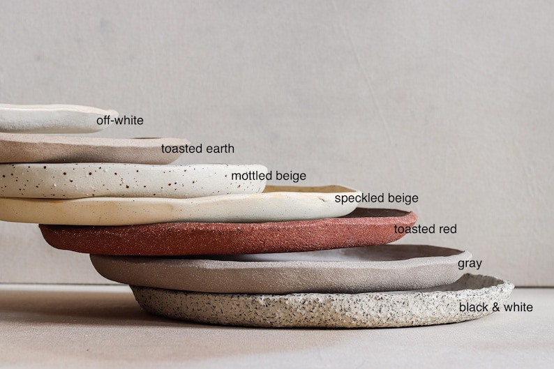 Seven stacked stoneware plates made from different clays to show the variety of shades available
