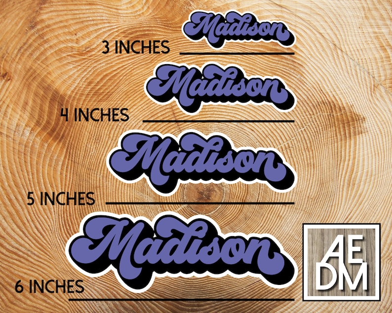May include: A selection of retro-style stickers featuring the name "Madison" in purple and black. Sizes available are 7.6, 10.2, 12.7, and 15.2 cm. The background is a wood grain pattern. The logo "AEDM" is in the bottom right corner.