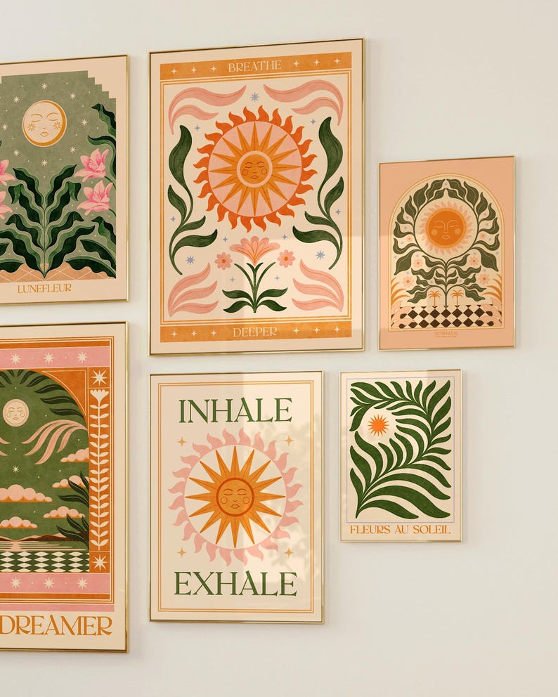 May include: Set of six framed prints with a whimsical, retro aesthetic. Each print features a sun with a face, surrounded by stylised flowers, leaves, and stars. The prints have a peach background with gold frames. The text on the prints includes "Breathe Deeper", "Inhale Exhale", "Dreamer", "Lunefleur", "Fleurs au Soleil", and "Breathe Deeper".