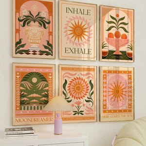May include: Set of six colourful illustrations with a retro aesthetic. The illustrations feature a sun, flowers, and plants in a pink, orange, and green colour scheme. The text on the illustrations includes "Inhale Exhale", "Breathe Deeper", "Here Comes the Sun", and "Moondreamer".