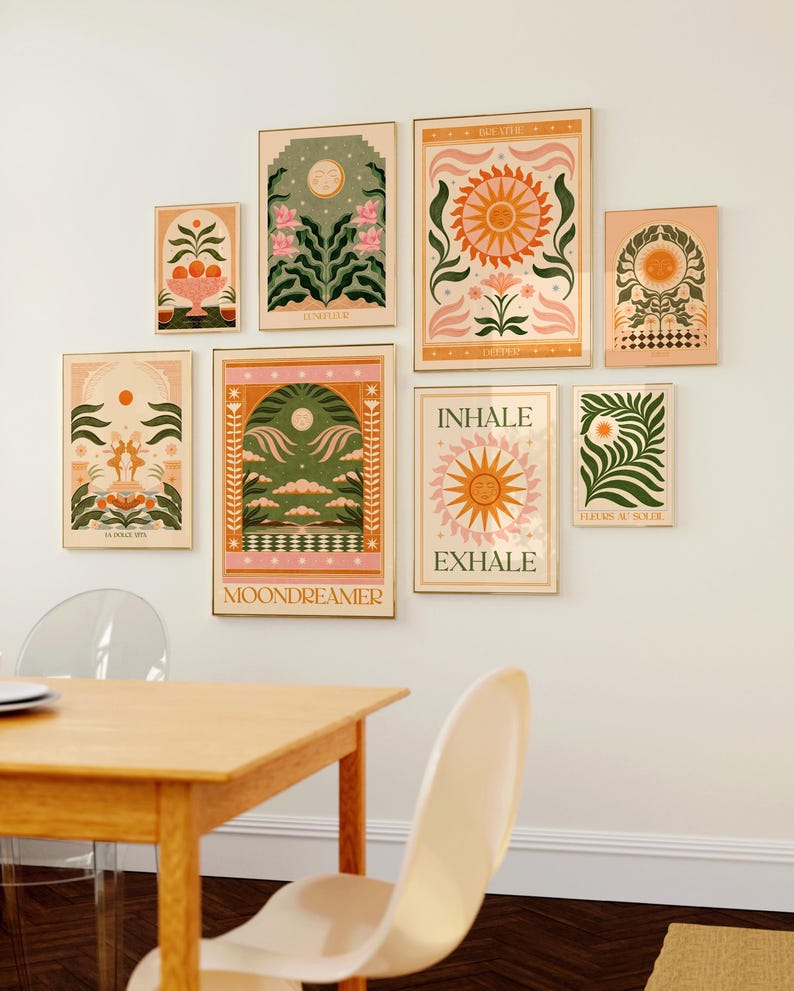 May include: A collection of eight framed prints with a nature theme. The prints feature illustrations of flowers, suns, moons, and other natural elements. The prints are in a variety of colours, including pink, green, yellow, and orange. The prints are arranged in a grid pattern on a white wall.