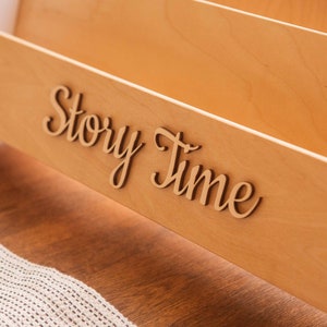 May include: Wooden book organizer with the words "Story Time" in cursive lettering.