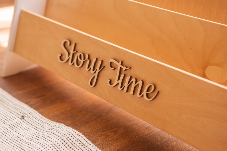 May include: Wooden book organizer with the words "Story Time" in cursive lettering.