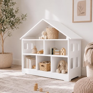 White wooden dollhouse shelf used for toy storage and pretend play in a Scandinavian nursery