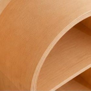 May include: A light brown, curved wooden shelf unit with two shelves. The unit has a rounded top and sides, and the wood grain is visible. The shelves are open and provide storage space. The design is modern and minimalist.