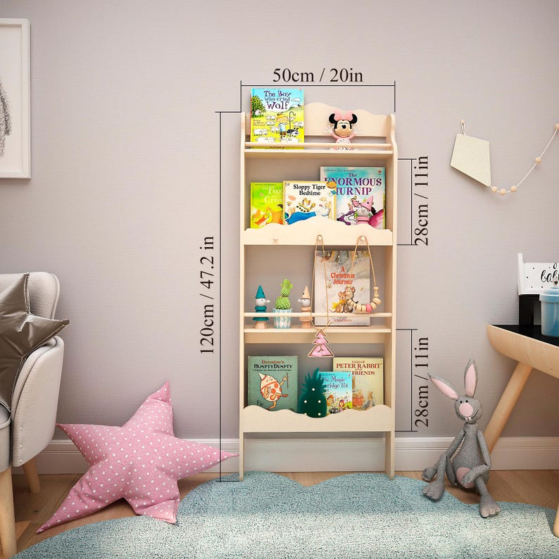 May include: A white wooden bookshelf with four shelves, measuring 20 inches wide, 47.2 inches tall, and 11 inches deep. The shelves are filled with children's books, including "The Boy Wolf", "Sleepy Tiger Bedtime", "The Enormous Turnip", "A Curious Journey", "Dumbledore's Birthday", "Magic Tree House", and "Peter Rabbit Friends".