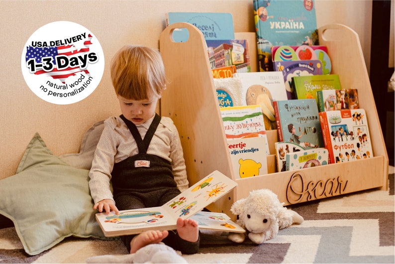 May include: A wooden bookshelf with a personalized name "Oscar" on the front. The bookshelf is filled with colorful children's books. A young child is sitting on the floor reading a book.