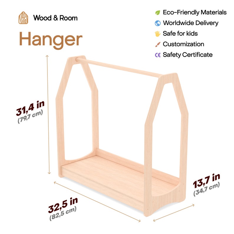 May include: A light-colored wooden clothing hanger rack with a house-shaped frame, featuring a horizontal bar and a base shelf. The rack measures 31.4 inches in height, 32.5 inches in width, and 13.7 inches in depth, labeled Wood & Room Hanger.
