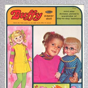 May include: A paper doll set featuring Buffy, the "little sister" from the CBS Family Affair TV show. The set includes a pink dress, a yellow dress, a skirt, a purse, and a bird.