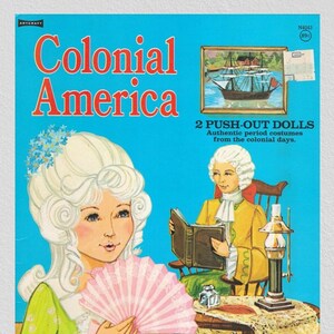 May include: A vintage paper doll set featuring two colonial figures, a woman with a white wig and a fan, and a man in a yellow jacket reading a book. The set includes the text "Colonial America" and "2 Push-Out Dolls".