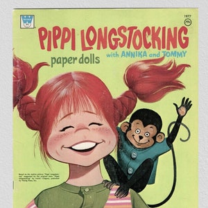 May include: A vintage paper doll book featuring Pippi Longstocking with Annika and Tommy. The cover features a colourful illustration of Pippi with her signature red braids and a monkey on her shoulder.