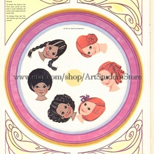 May include: A paper doll wheel with four different hairstyles for girls. The wheel is pink, yellow, and orange. The hairstyles are black, brown, and red. The text on the wheel says "Change-A-Hairdo Wheel".