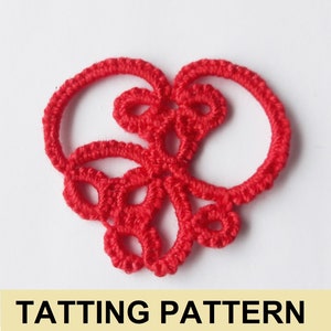 May include: A red heart-shaped tatting pattern. The pattern is made of small, intricate knots and loops.
