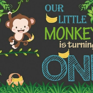 May include: A chalkboard style birthday sign with a cartoon monkey holding a banana. The sign says "Our Little Monkey is turning One" in green, blue, and yellow text.