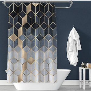 May include: A shower curtain featuring a geometric pattern of gold and blue squares. The curtain is hanging in a bathroom with a white bathtub and a white towel hanging on a hook.