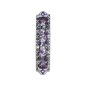 May include: A silver mezuzah case with a floral design. The case is decorated with pink, purple, and green enamel and rhinestones. The Hebrew letter "Shin" is visible in the center of the case.