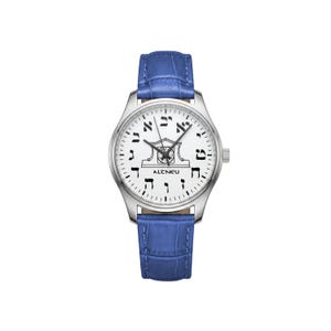 May include: A silver wristwatch with a white face and blue leather strap. The watch face displays black Hebrew numerals and a decorative emblem. The strap is textured blue, and the watch has a silver bezel.