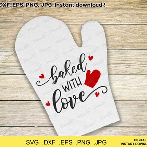 May include: White oven mitt with the text "baked with love" in black cursive font. There are five red hearts around the text. The oven mitt is on a wood background.
