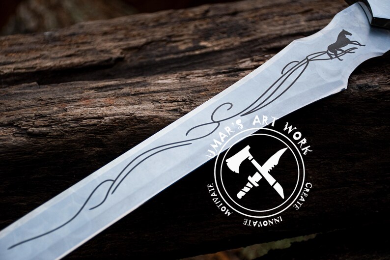 May include: A close-up of a silver sword with a decorative design and a horse etched into the blade. The sword is resting on a wooden surface. The image also includes a logo with the text "UMAR'S ART WORK" and the words "CREATE, INNOVATE, MOTIVATE" around the logo.