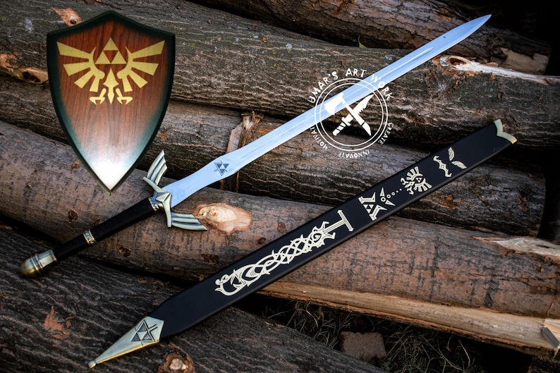 May include: A wooden shield with a gold emblem, a silver sword, and a black scabbard with silver designs. The sword has a silver hilt and a blue blade. The items are displayed on a background of wooden logs.