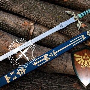 May include: A fantasy sword with a blue and white handle, silver blade, and gold accents, along with a matching blue sheath and a wooden shield. The sword and shield are displayed on a background of wooden logs. The image includes the text "UMAR'S ART WORK".