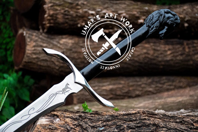 May include: A silver sword with a black handle and a horse engraved on the blade. The handle has a black circular design with the text "UMAR'S ART WORK" and the words "CREATE", "INNOVATE", "MOTIVATE" around the circle.