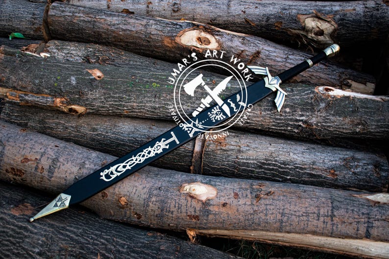 May include: A black sword with silver accents and a decorative design, resting on a pile of logs. The sword features a detailed hilt and blade design. The image includes a circular logo with text that reads "UMAR'S ART WORK".