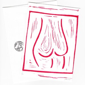 May include: A red and white linocut print with an abstract design of curved lines within a rectangular border. The print is on white paper, with a matching white envelope. The envelope has a small circular design with the word "Hey" in a script font.