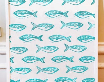 May include: Framed art print with a repeating pattern of turquoise fish on a white background. The fish are stylised with detailed linework, and the print is encased in a white wooden frame, ideal for wall decor.