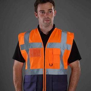 May include: A bright orange safety vest with reflective strips and multiple pockets. The vest has a zipper closure and a navy blue bottom section.