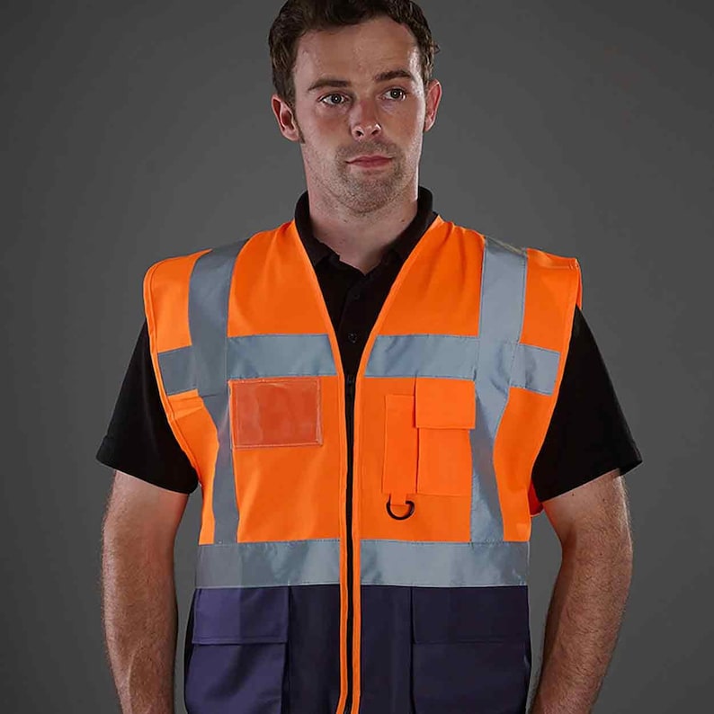 May include: A bright orange safety vest with reflective strips and multiple pockets. The vest has a zipper closure and a navy blue bottom section.