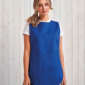 May include: A royal blue sleeveless apron with a single large pocket on the front. The apron is made of a smooth, durable fabric.