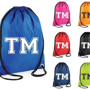 May include: Drawstring bags in a range of colours: blue, pink, orange, red, black, navy, and lime green. Each bag displays the white letters "TM" in a collegiate font. The bags have black drawstrings.