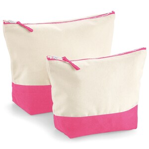May include: Two canvas zippered pouches with pink trim. The larger pouch is behind the smaller pouch.