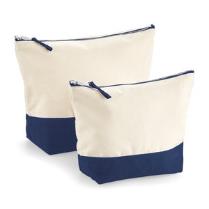 May include: Two canvas zippered pouches with a navy blue bottom. The larger pouch is behind the smaller pouch.