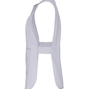 May include: A light gray sleeveless apron with a single pocket on the left side. The apron has a strap that goes around the neck and ties at the back.