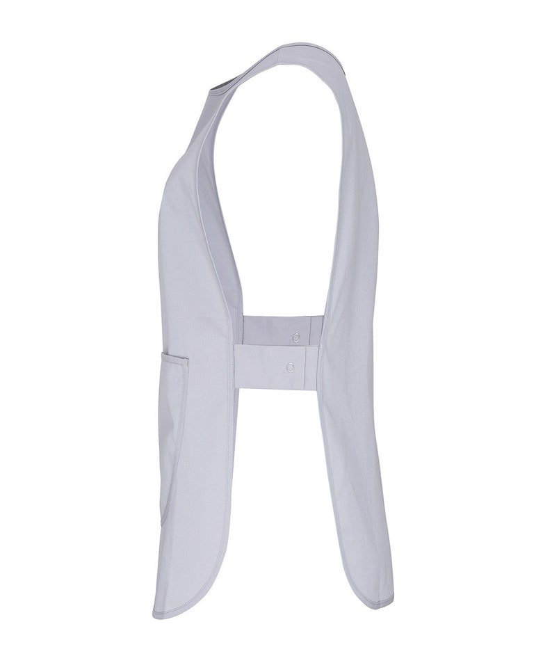 May include: A light gray sleeveless apron with a single pocket on the left side. The apron has a strap that goes around the neck and ties at the back.