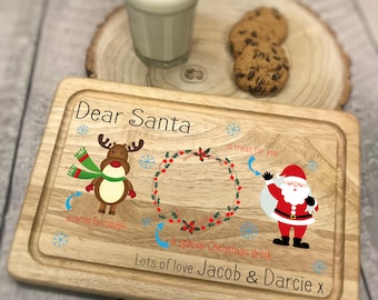 May include: Wooden serving board with a festive design for Santa. Features a reindeer, Santa Claus, and text that reads "Dear Santa" and "Lots of love Jacob & Darcie x". Includes a glass of milk and cookies.