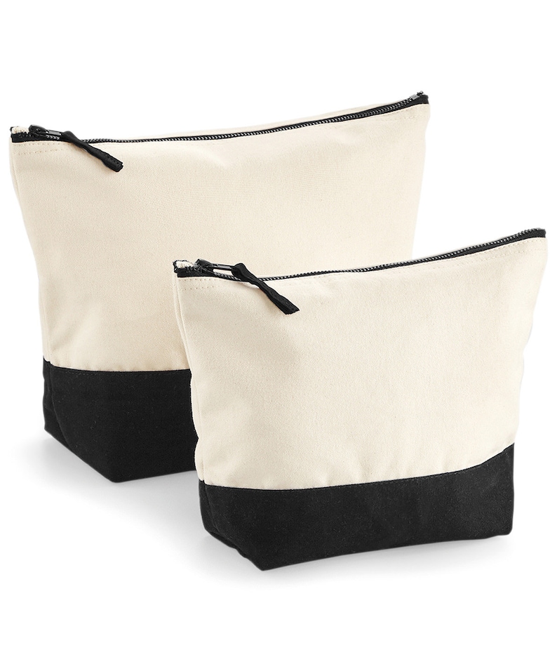 May include: Two canvas zippered pouches with black bottoms. The larger pouch is behind the smaller pouch.