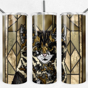 May include: A stainless steel tumbler with a colorful stained glass design featuring a cat. The design is in shades of brown, gold, and black.