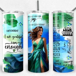May include: Three stainless steel tumblers with inspirational quotes and watercolor designs. The tumblers feature a woman in a green dress, a green and blue watercolor design, and a blue and green watercolor design.