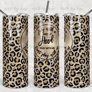 May include: A gold and black leopard print tumbler with the text "Don't play with a hint of hood pray with me" in a circle.
