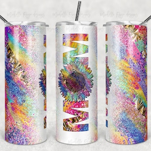 May include: A white tumbler with a colorful design featuring a sunflower and glitter. The design is in shades of pink, blue, yellow, and green.