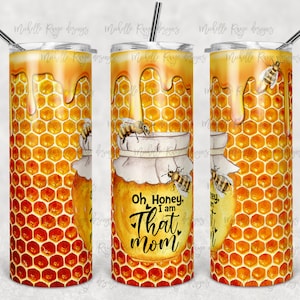 May include: A stainless steel tumbler with a honeycomb pattern and dripping honey. The tumbler has a white lid and a straw. The tumbler has the text "Oh, Honey, I am That Mom" on the front.