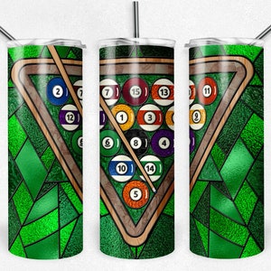 May include: A stainless steel tumbler with a green and brown stained glass design of a pool table with billiard balls numbered 1 through 15. The tumbler has a straw and a lid.