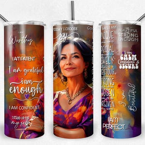 May include: A stainless steel tumbler with a straw, featuring a portrait of a woman and inspirational text. The tumbler has a colorful abstract background with phrases like "I am worthy" and "I am beautiful."