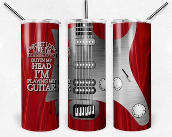 May include: A red and silver stainless steel tumbler with a guitar graphic and the text "I might look like I'm listening to you but in my head I'm playing my guitar".