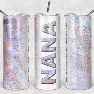 May include: A white tumbler with a glittery, abstract design in shades of pink, purple, and blue. The word "NANA" is printed in large, bold letters on the front of the tumbler.